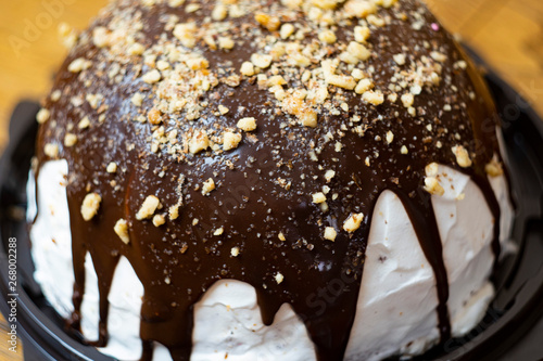 Close-up, delicious and appetizing souffle cake with chocolate sprinkled with nuts