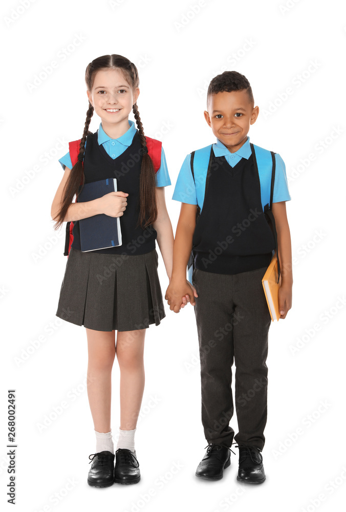 Full length portrait of cute children in school uniform with books on white background Full length portrait of cute children in school uniform with books on white background