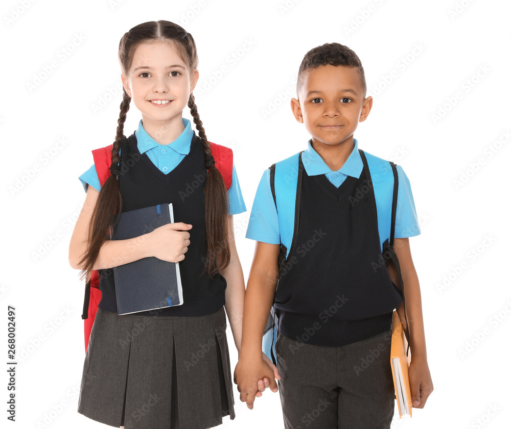 Portrait of cute children in school uniform with books on white background Portrait of cute children in school uniform with books on white background