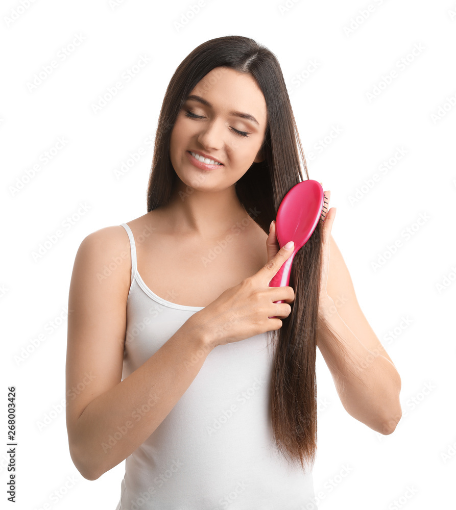 Beautiful young woman with hair brush on white background Beautiful young woman with hair brush on white background