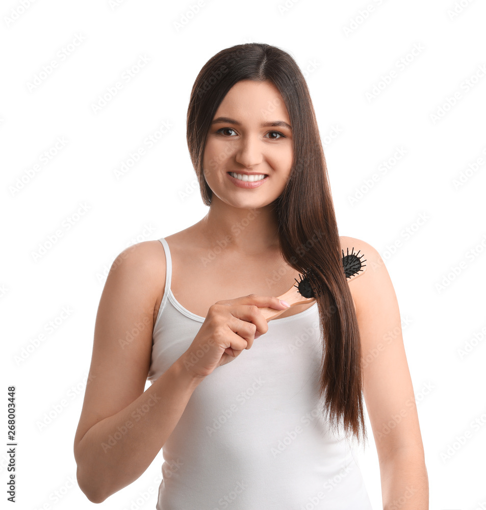 Beautiful young woman with hair brush on white background Beautiful young woman with hair brush on white background