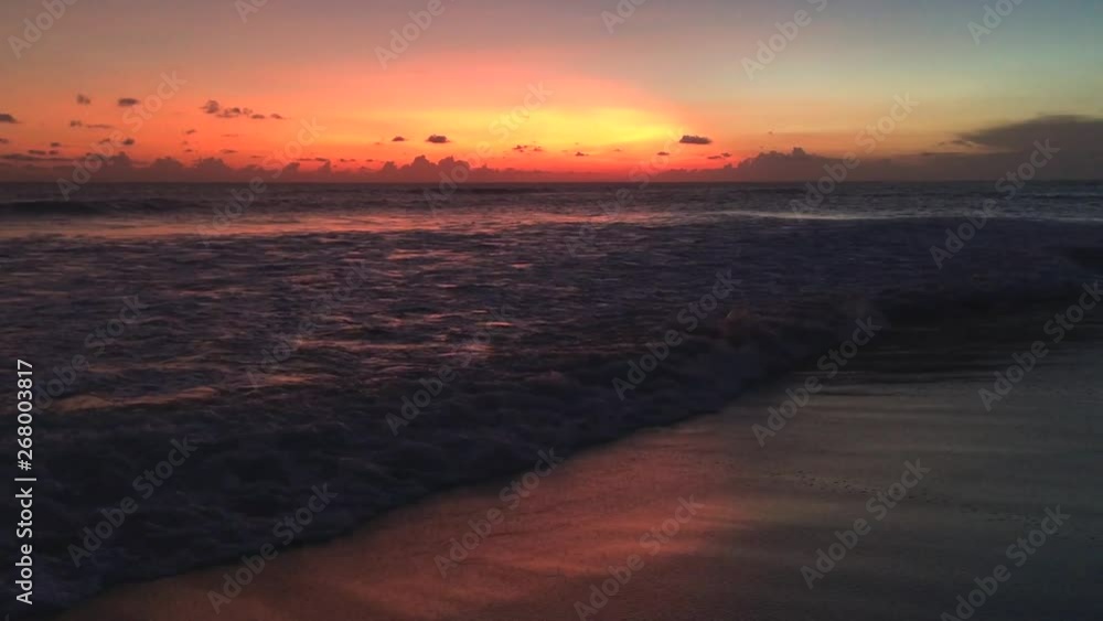 Beautiful cloudscape over the sea with waves and people silhouette during sunset, Bali, Indonesia, 4k footage video Beautiful cloudscape over the sea with waves and people silhouette during sunset, Bali, Indonesia, 4k footage video