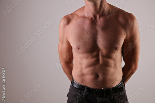 Strong Athletic Man muscular body, torso, and six pack abs close up, copy space