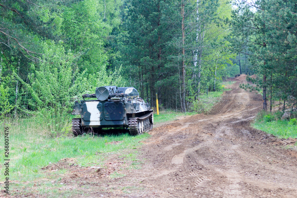 Fototapeta premium forest. worth infantry fighting vehicle. road share of military equipment. have toning