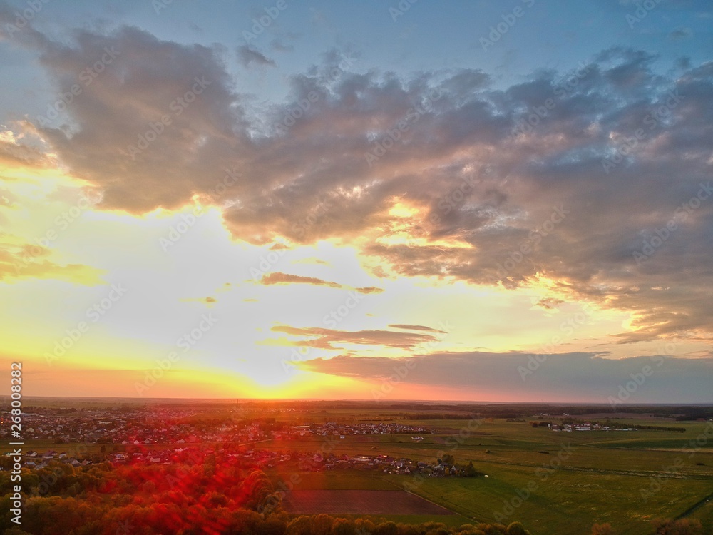 sunset over green field in Minsk Region of Belarus