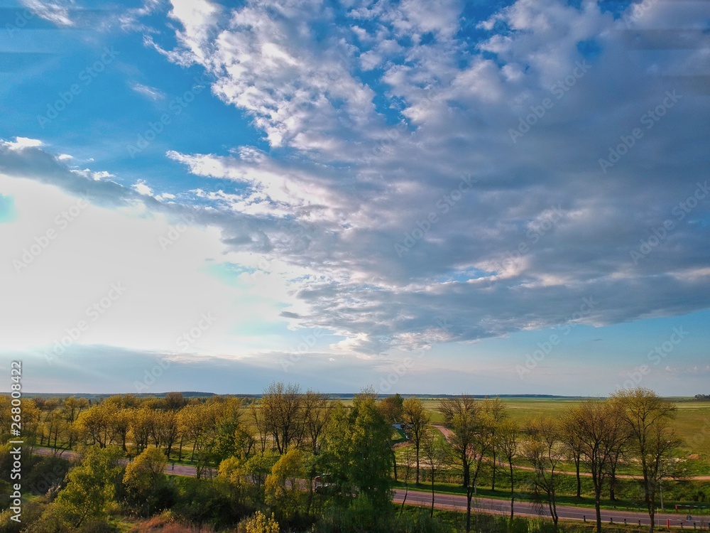 landscape with green field and blue sky in Minsk Region of Belarus