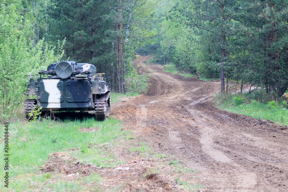 Fototapeta premium forest. worth infantry fighting vehicle. road share of military equipment. have toning