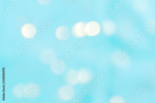 Abstract sea blue color blurred background. Unfocused festive backdrop with light bokeh