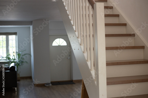 White wooden stairs  in white house interior © Iryna