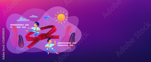 Young athletes doing karate outside at summer camp and big belt, tiny people. Karate camp, kids boxing club, fighting sport section concept. Header or footer banner template with copy space.