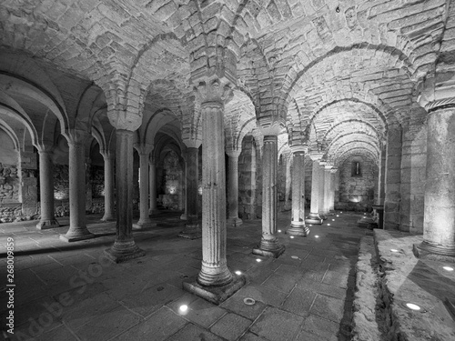 Fototapeta Crypt of a medieval abbey with carved stone columns.