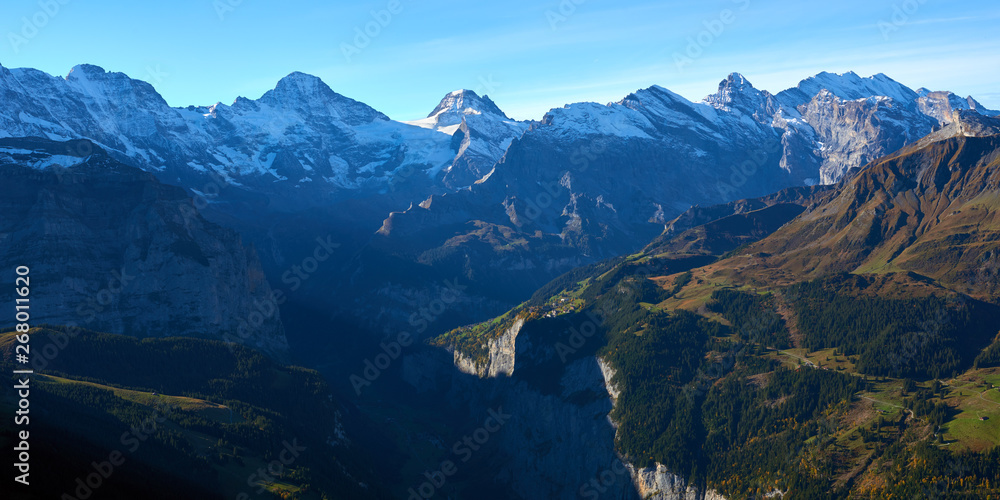 Panoramic view of the mountains at sunrise in Lauterbrunnen valley in Switzerland.