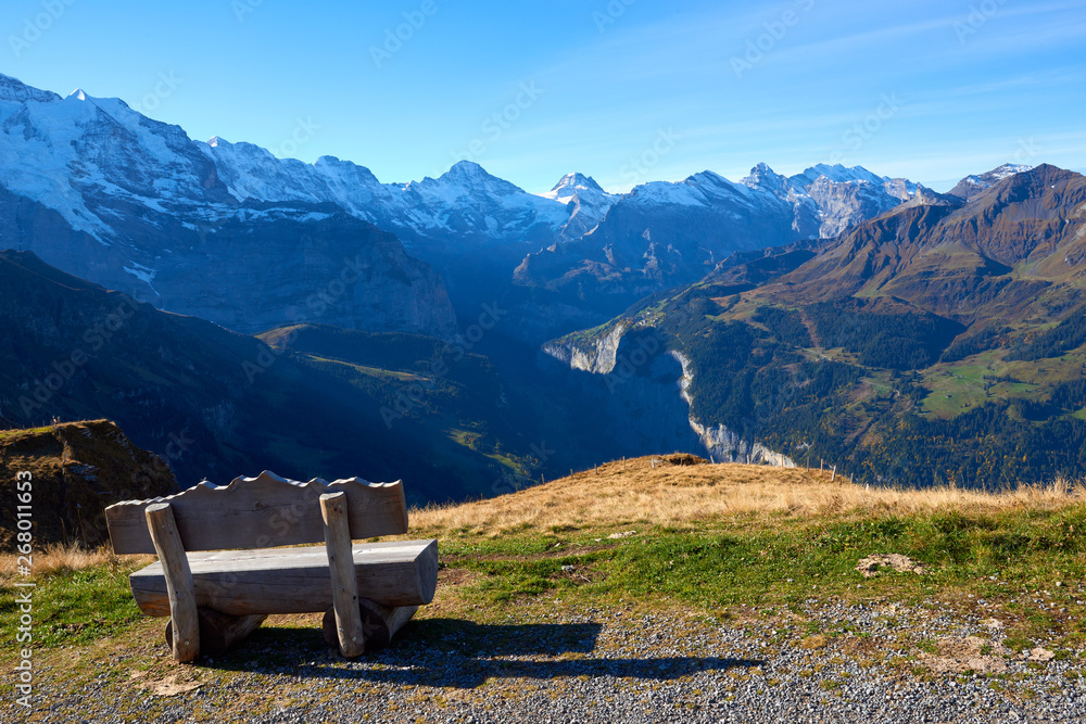 The wooden bench with the beautiful view to Lauterbrunnen valley and the mountains panorama in Switzerland. The wooden bench with the beautiful view to Lauterbrunnen valley and the mountains panorama in Switzerland.