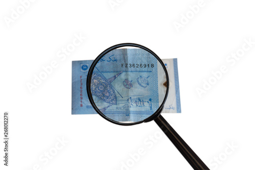 one Malaysia Ringgit and magnifying glass isolated on white background, reverse side