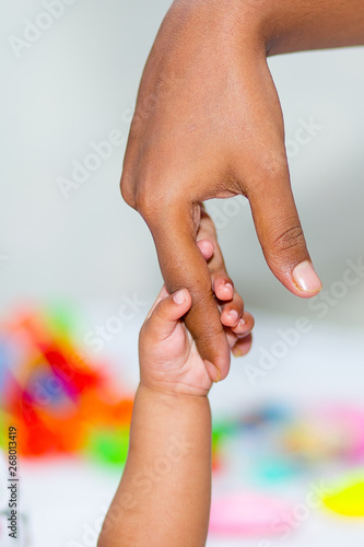 A asian baby hand holding mother finger