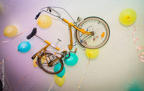 a bicycle on the ceiling with balloons 