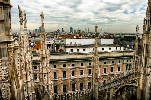 The spires of white marble that adorn the Milan Cathedral Duomo. Milan, Lombardy, Italy. Landscape city view from Duomo terrace. May 2012