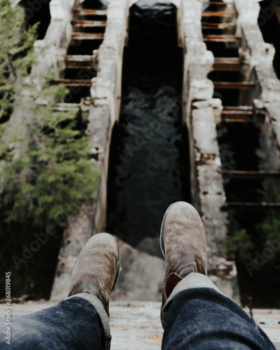 bokeh photography of person wearing pair of brown shoes photo