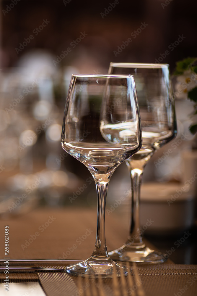 a pair of wine glasses at a banquet table a pair of wine glasses at a banquet table