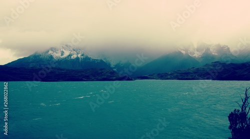 Chile Patagonia Torres del Plaine.  With turquoise colored lake in front of snow covered mountain. 