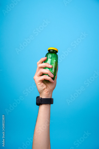 hand holding glass bottle