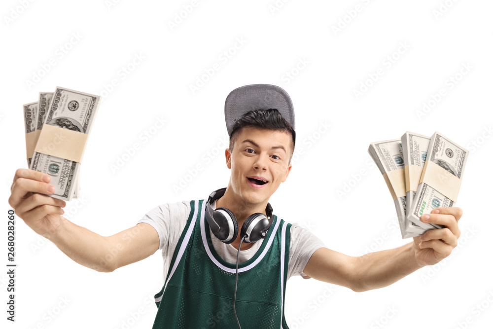Cheerful young guy with bundles of money isolated Cheerful young guy with bundles of money isolated