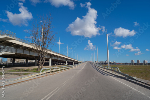 Open space with road signs and road markings, road intersections, pedestrian crossings, sunny day, blue sky, city landscape background