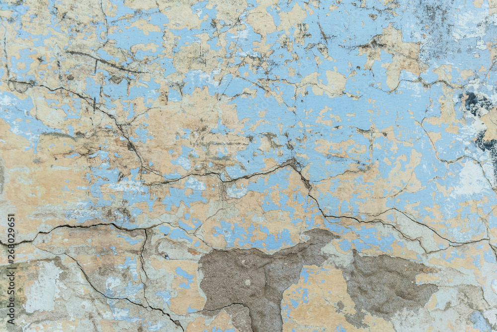 background of a shabby old wall painted in yellow and blue