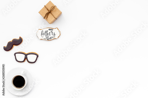 moustache, glasses, coffee, gift and copy for Happy Father Day party on white background top view copy space photo