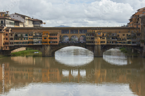 The Ponte Vecchio - a medieval stone closed-spandrel segmental arch bridge over the Arno River, in Florence, Italy, noted for still having shops built along it, as was once common. 