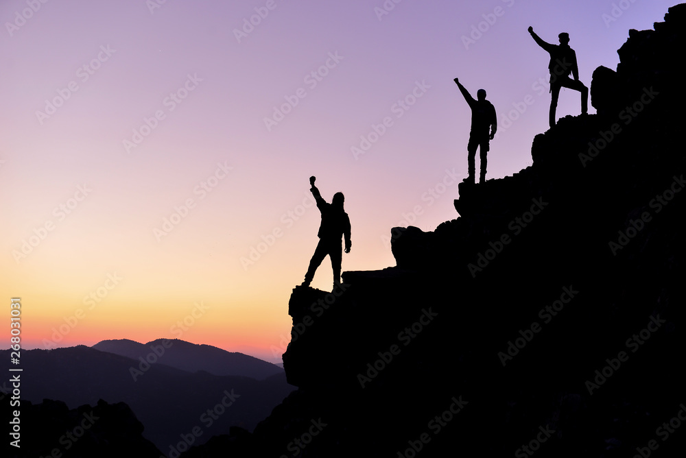 successful people on the peaks of mountains
