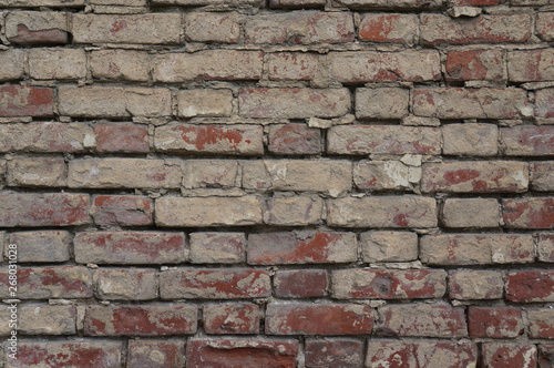 Old vintage dirty brick wall with peeling plaster. Texture  background
