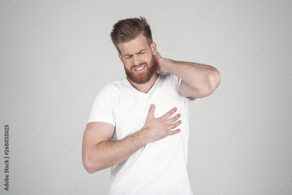 Portrait of beautiful sexy bearded man. He has a heartbeat, he stands in front of a white background Portrait of beautiful sexy bearded man. He has a heartbeat, he stands in front of a white background