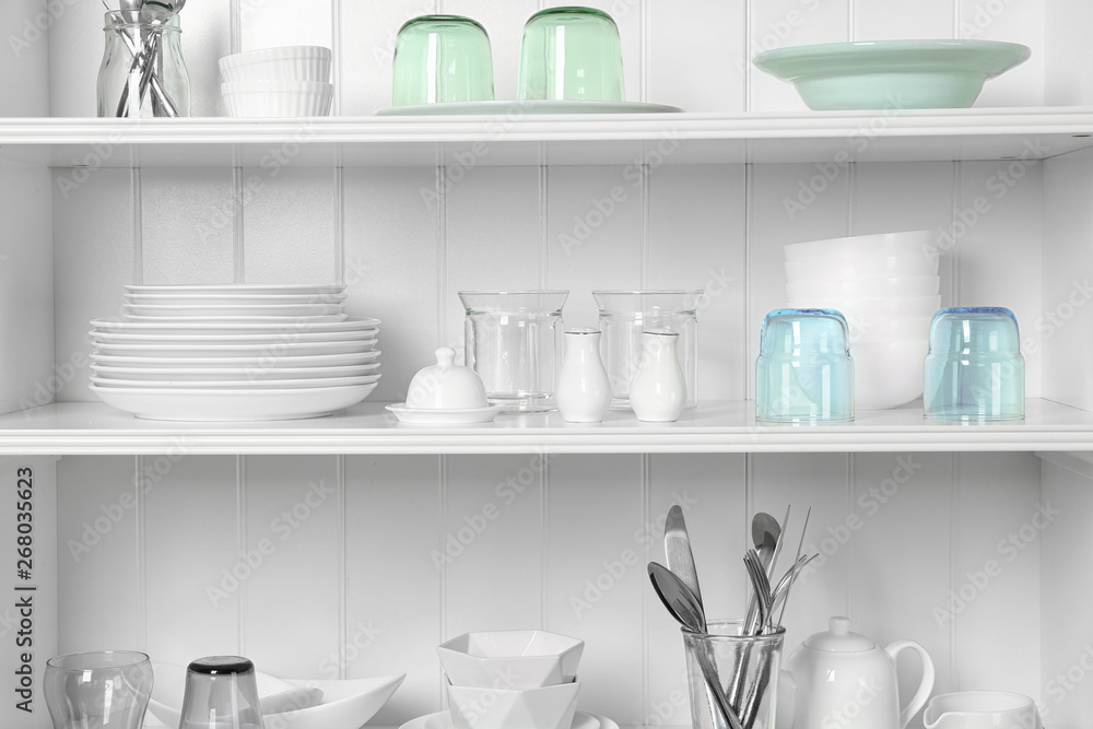White shelving unit with set of dishware White shelving unit with set of dishware