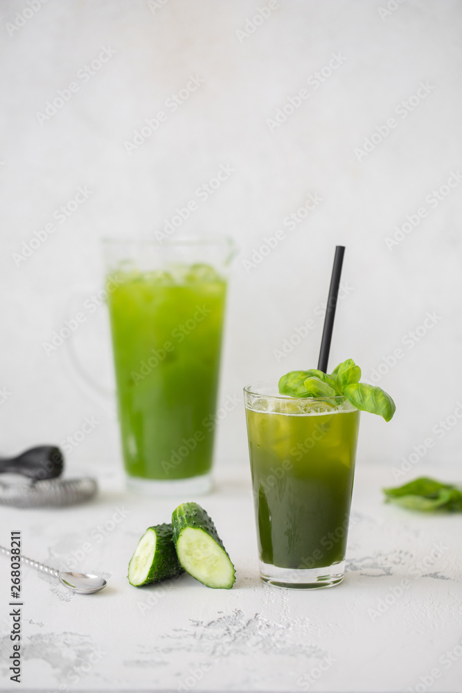 Refreshing cucumber basil lemonade. Poured into a glass and carafe