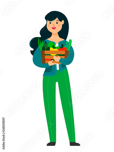 Funny girl is holding a box with fruits, vegetables and herbs. Vector illustration in cartoon style on a white background.