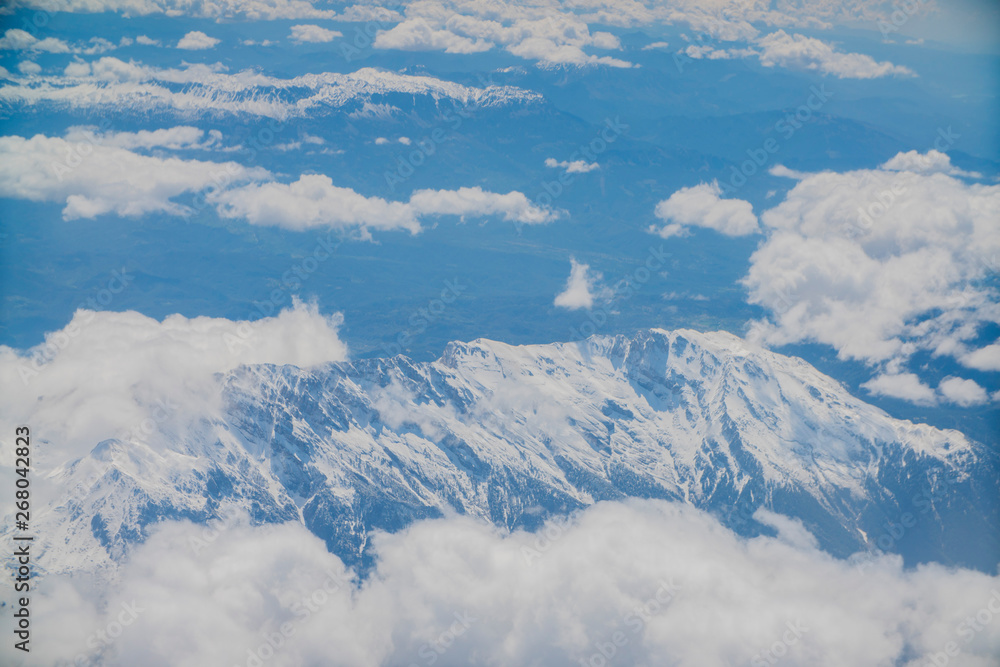 top view of clouds and mountains from the plane