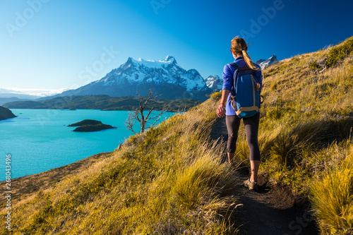 Woman hiker walks on the trail in the Torres del Paine National Park. Chile