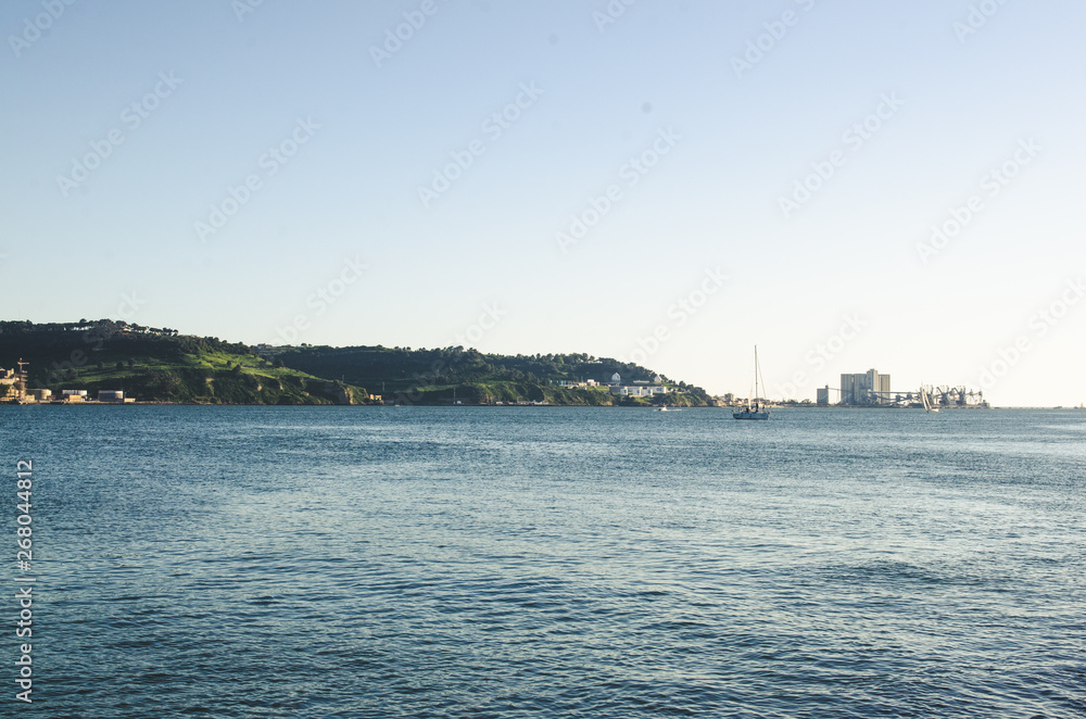 Lisbon landscape with river yacht and mountains