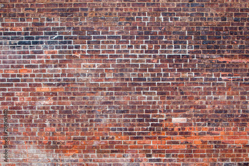Empty old retro red brick wall background on sunny summer day in Brooklyn, New York, USA