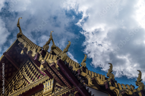 The roof of the Thai temple, along with the gable at the top of the church with a sky backdrop