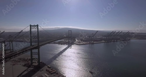 Aerial, drone shot, of the Vincent Thomas Bridge, traffic on seaside freeway 47 and towards the Terminal island, on a sunny day, at Long Beach, in San Pedro, Los Angeles, California, USA photo