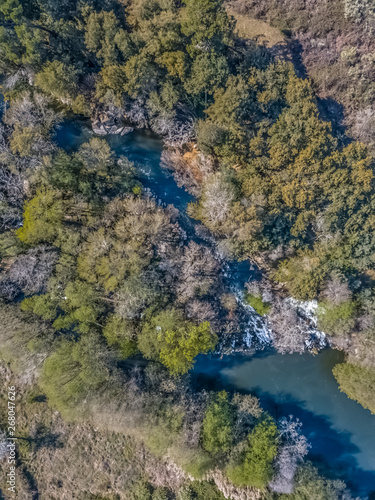 Aerial view of drone, natural landscape river with and colored trees on the banks