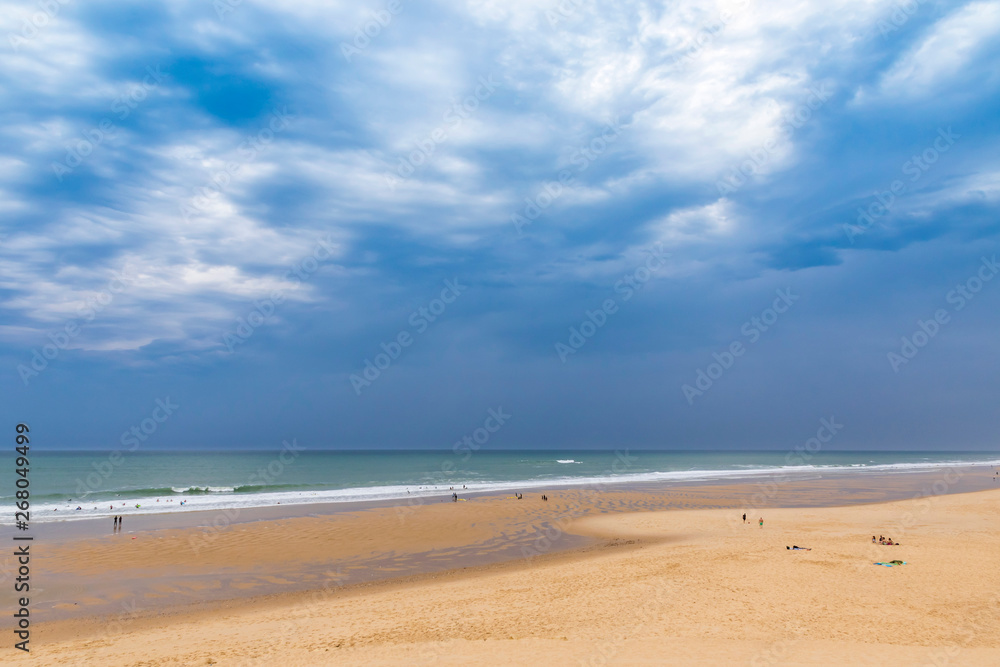 Ocean beach on the Atlantic coast of France near Lacanau-Ocean, Bordeaux, France. Windy and cloudy summer day