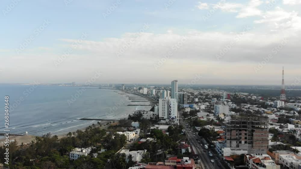 Aerial panoramic view of Boca del Rio in Veracruz with drone descending slowly with a blue and cloudy sky as background Aerial panoramic view of Boca del Rio in Veracruz with drone descending slowly with a blue and cloudy sky as background