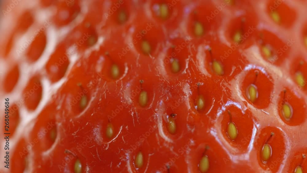 Macro shot of fresh red strawberry rotating on dark surface. 4K close up footage. Macro shot of fresh red strawberry rotating on dark surface. 4K close up footage.
