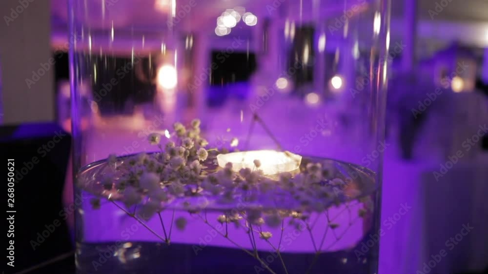 Wedding decoration in a night room, vase with flowers and water. Wedding decoration in a night room, vase with flowers and water.