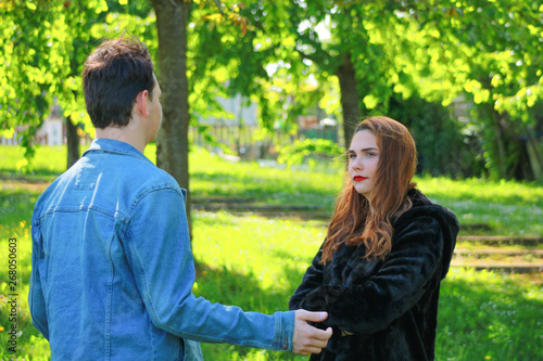  A couple of friends arguing outside. Beautiful girl with makeup and long red hair. Boy with jeans jacket  © Bruno