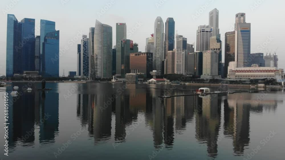 Aerial panoramic view of the financial district in Singapore with drone hovering over the bay Aerial panoramic view of the financial district in Singapore with drone hovering over the bay
