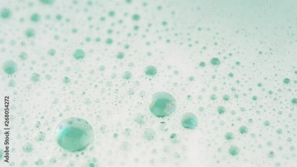 Close up of soap foam in light green pastel water. 4K macro footage. Close up of soap foam in light green pastel water. 4K macro footage.